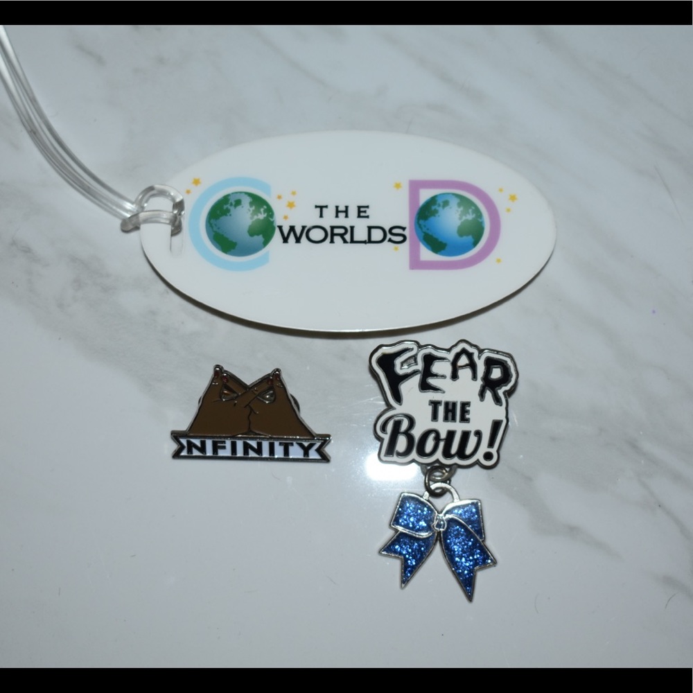 2 PINS FROM POP UP SHOP AND WORLDS TAG